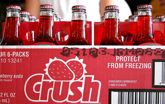cans of a red soda in a 6-pack reading the word `Crush`
